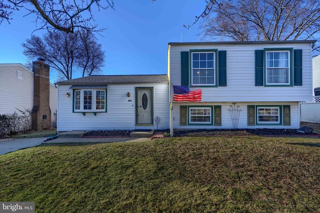 split level home featuring a front lawn