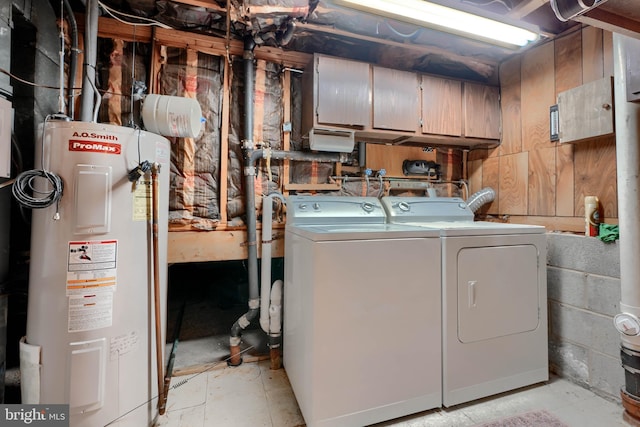 clothes washing area featuring washing machine and dryer and water heater