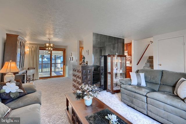 living area featuring light carpet, stairway, a textured ceiling, and an inviting chandelier