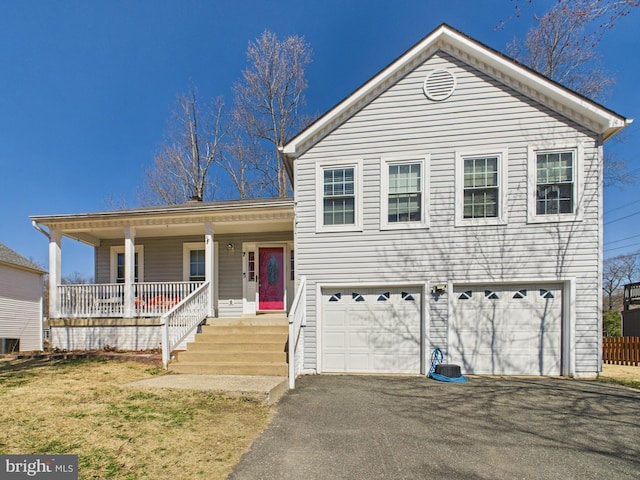 tri-level home featuring aphalt driveway, a porch, and a garage