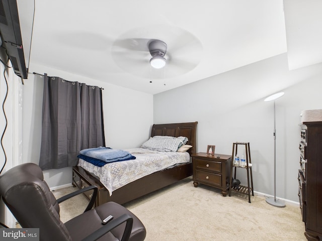 bedroom featuring light colored carpet, baseboards, and ceiling fan