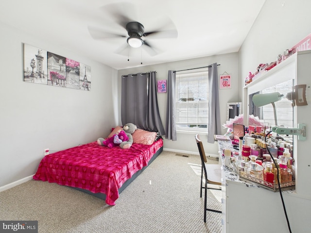 carpeted bedroom featuring multiple windows, baseboards, and visible vents