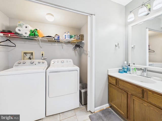 laundry room with a sink, light tile patterned flooring, laundry area, and washer and clothes dryer