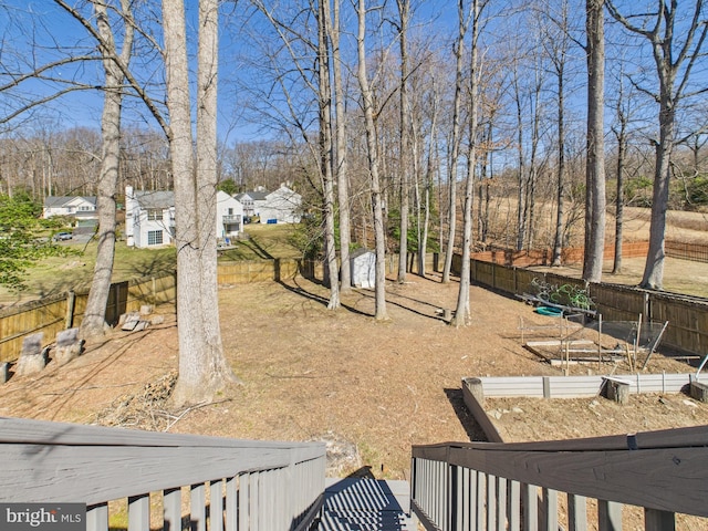 view of yard with a fenced backyard and a vegetable garden