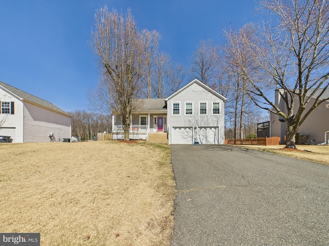 view of front of house featuring aphalt driveway, a porch, and a garage