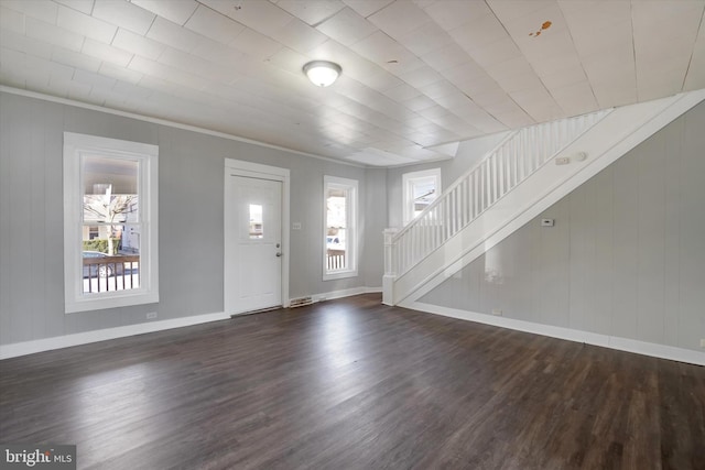 entryway with visible vents, baseboards, dark wood-style floors, and stairs