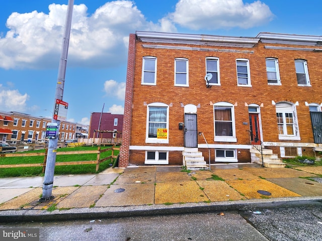 multi unit property featuring brick siding and entry steps