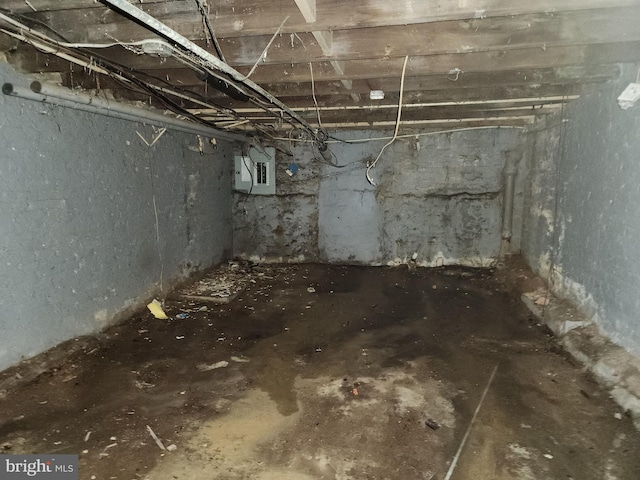 unfinished basement featuring electric panel