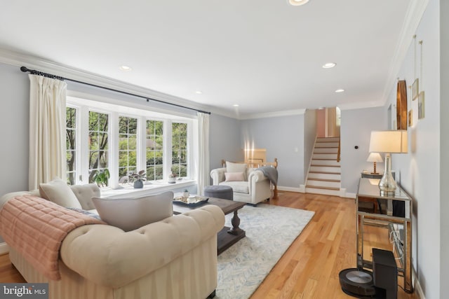 living area with recessed lighting, light wood-style floors, stairs, and crown molding