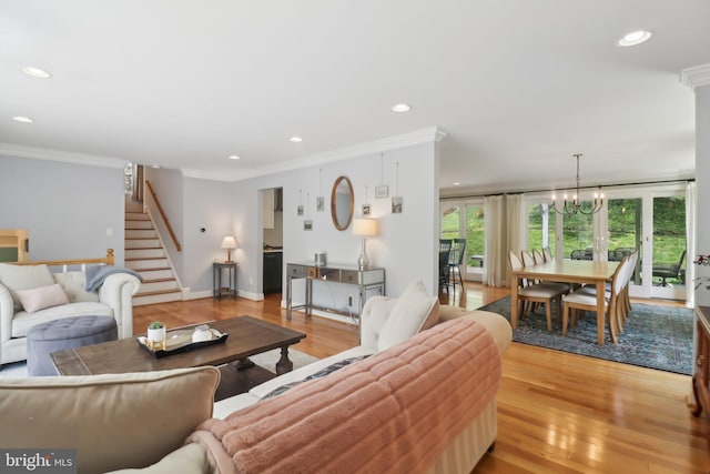 living area featuring crown molding, stairs, light wood finished floors, and recessed lighting