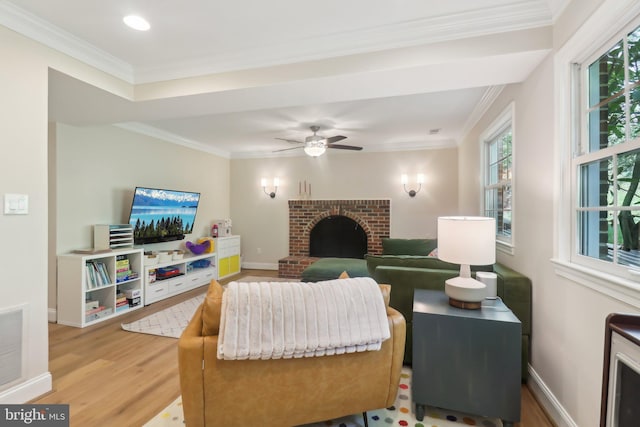 living area featuring a fireplace, crown molding, visible vents, and light wood finished floors