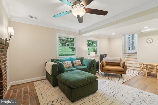 living room featuring plenty of natural light, visible vents, baseboards, and ceiling fan