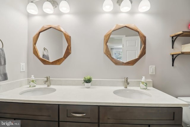 bathroom with a sink and double vanity