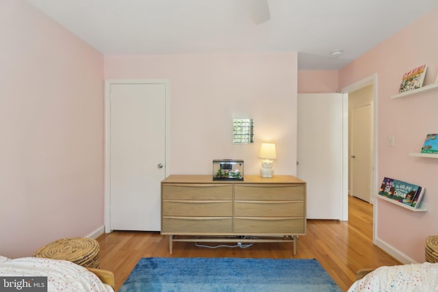 bedroom with baseboards and light wood-style floors