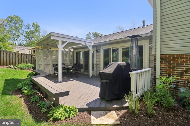 wooden terrace with fence and a grill