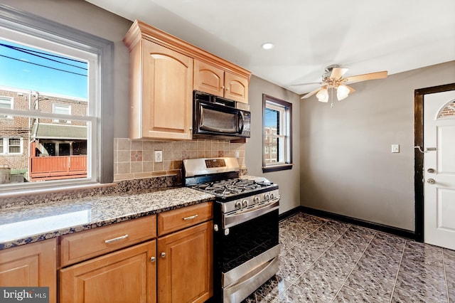 kitchen with light brown cabinetry, a healthy amount of sunlight, black microwave, and stainless steel range with gas cooktop