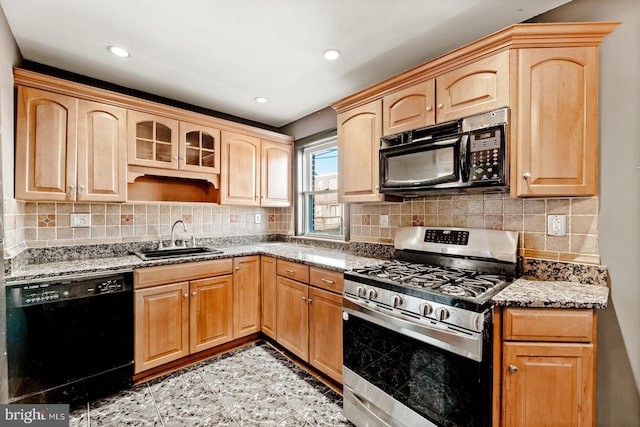 kitchen with black appliances, light stone countertops, light brown cabinets, and a sink