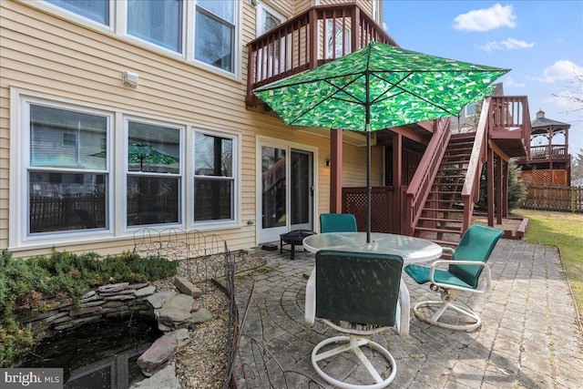 view of patio / terrace with outdoor dining space and stairs