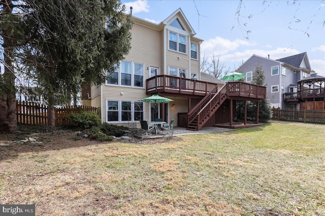 back of house featuring a patio, a fenced backyard, stairs, a deck, and a lawn