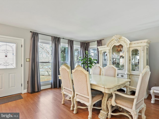 dining area featuring wood finished floors and baseboards