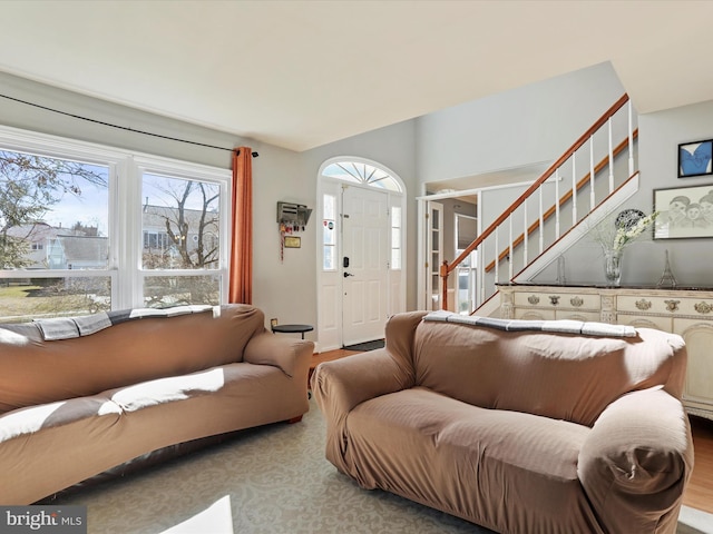 living area featuring stairs and wood finished floors