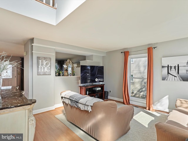 living room featuring light wood finished floors and baseboards