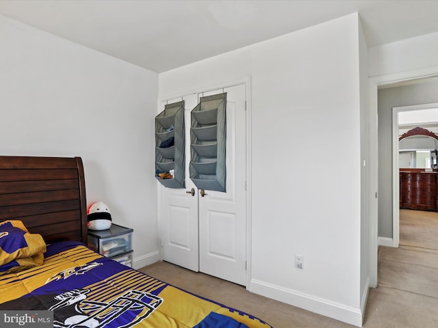 carpeted bedroom featuring baseboards