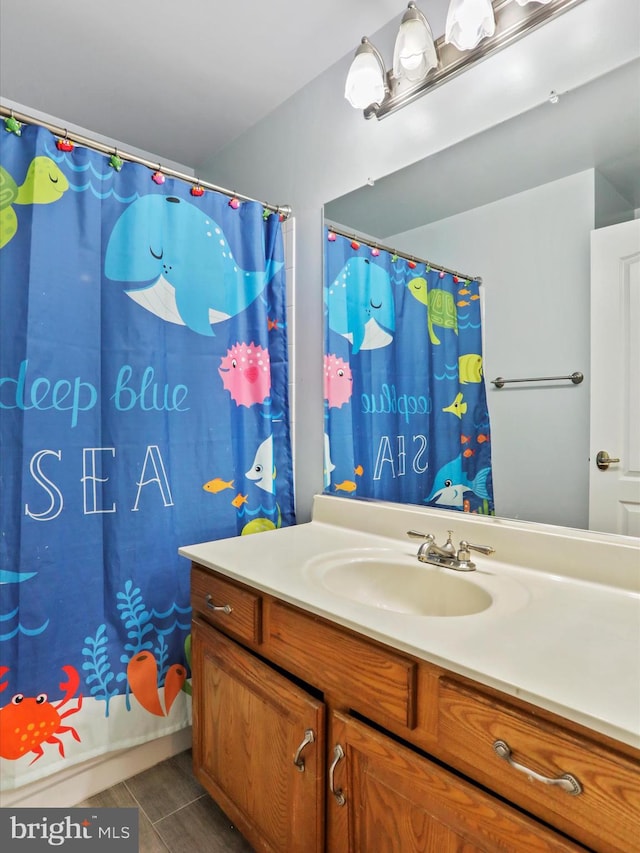 bathroom featuring vanity, tile patterned floors, and a shower with curtain