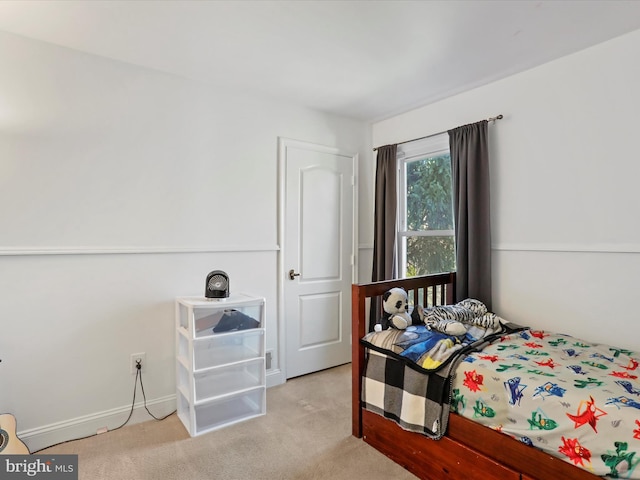 carpeted bedroom featuring baseboards