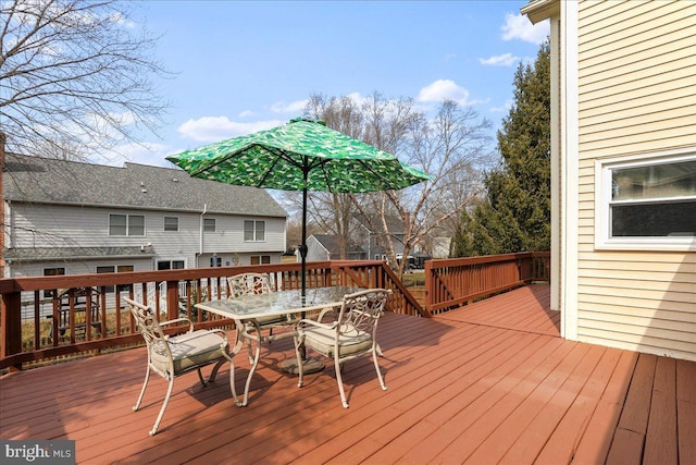 wooden terrace featuring outdoor dining space