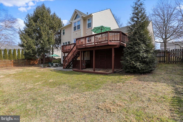 back of property featuring stairway, a lawn, a fenced backyard, and a deck