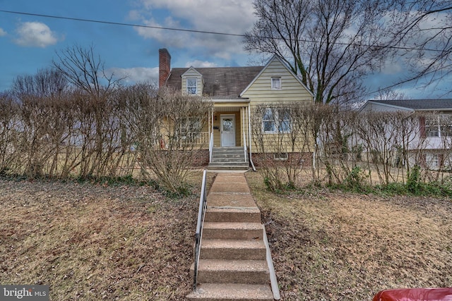 view of front of house featuring a porch and a chimney