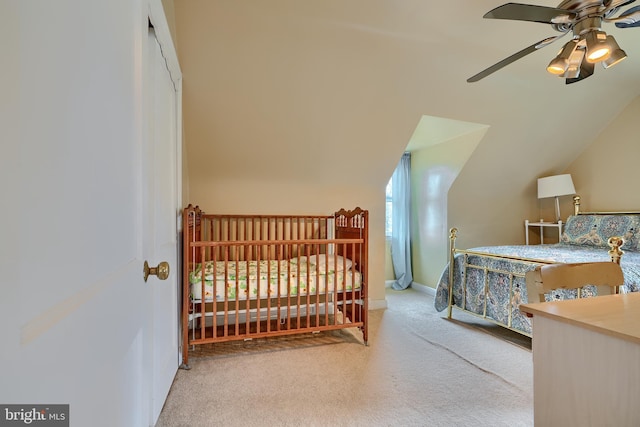 carpeted bedroom with ceiling fan, baseboards, and lofted ceiling