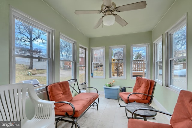 sunroom featuring ceiling fan