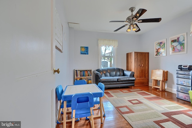 game room with hardwood / wood-style flooring and a ceiling fan