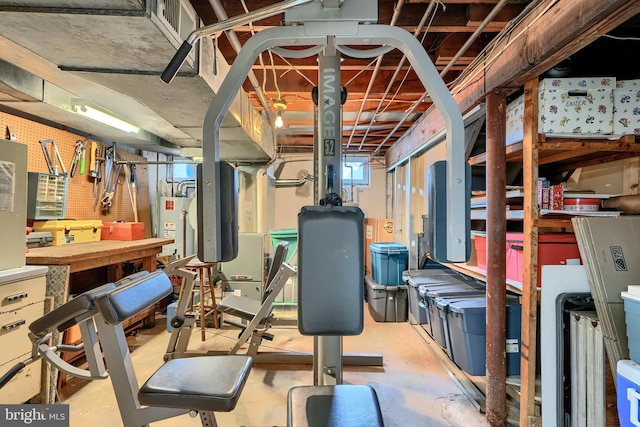 workout area with gas water heater and a workshop area