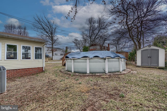 view of yard with a covered pool, an outbuilding, a storage unit, and cooling unit