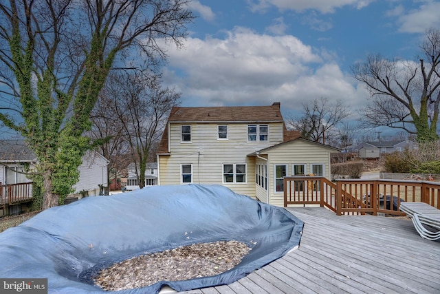 back of property with a wooden deck