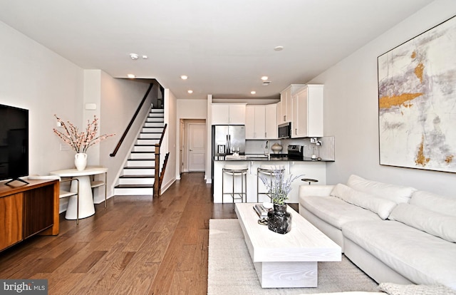 living area featuring stairs, recessed lighting, and wood finished floors