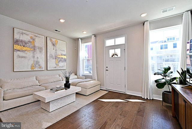 living room featuring recessed lighting, visible vents, baseboards, and dark wood-type flooring