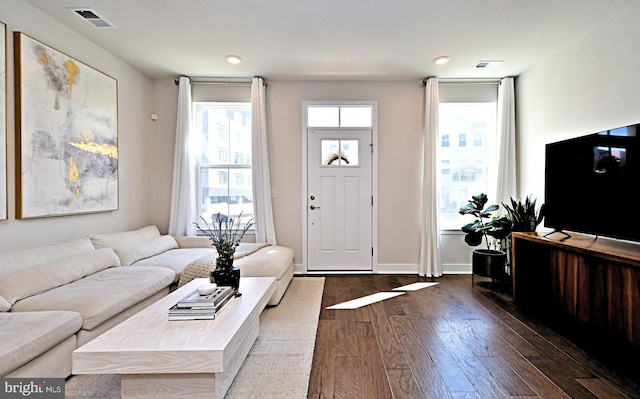 foyer featuring visible vents, baseboards, and dark wood-style floors