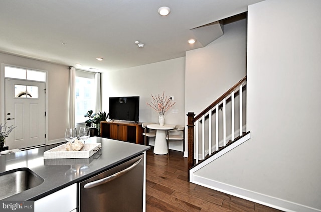 kitchen featuring baseboards, recessed lighting, dark wood-type flooring, dishwasher, and dark countertops