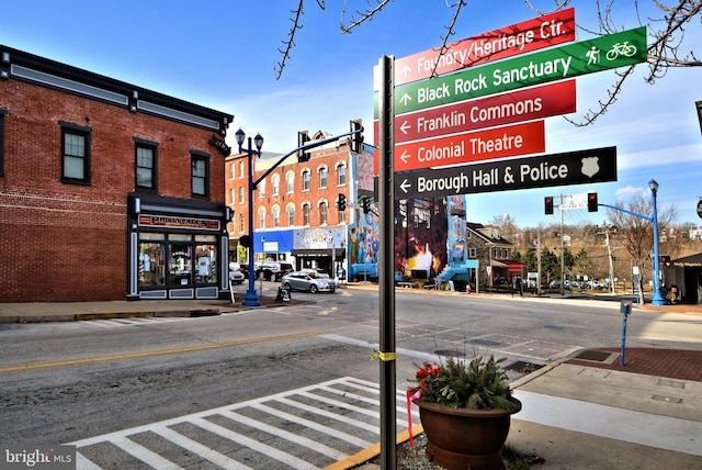 view of street with sidewalks, curbs, and street lighting