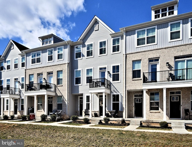 view of property featuring brick siding and a residential view