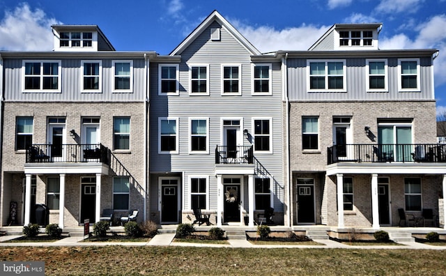 townhome / multi-family property featuring brick siding