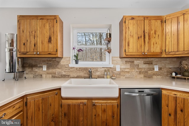 kitchen with dishwasher, decorative backsplash, brown cabinets, and a sink