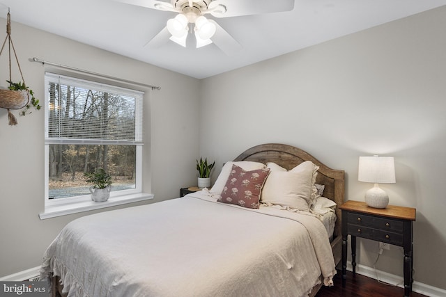 bedroom with dark wood finished floors, baseboards, and ceiling fan