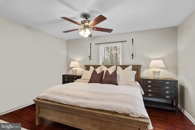 bedroom with a ceiling fan, wood finished floors, and baseboards