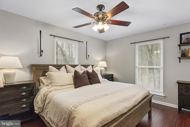 bedroom with dark wood-style floors, ceiling fan, and baseboards