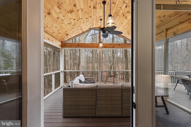 unfurnished sunroom with wooden ceiling, a ceiling fan, and vaulted ceiling